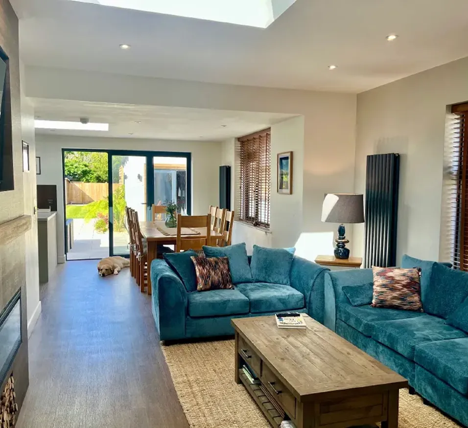 Open-plan lounge and dining area at dog-friendly holiday bungalow in Berrow near Brean with garden views